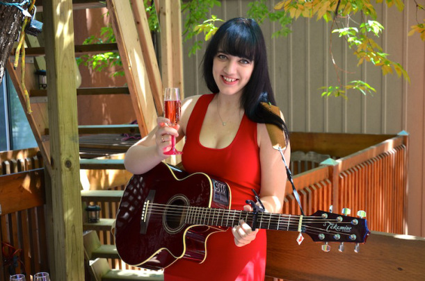 Sage playing guitar at the Jeanne Lottie 28th anniversary party