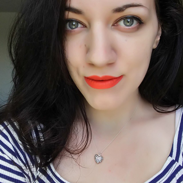 Stripes, a heart locket, orange lips and #nofilter.